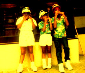 Erica Campbell, Mark Alexander and Jemeul Campbell in New Orleans blowing their Harmonicas.